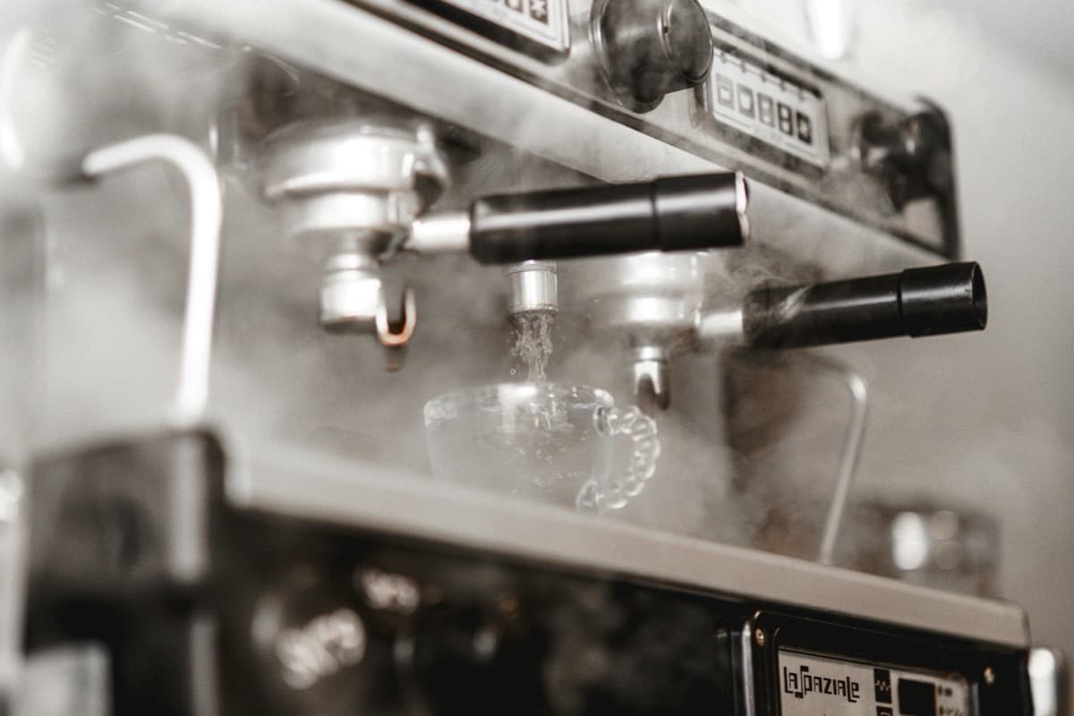 Portafilter machine running water into a glass cup